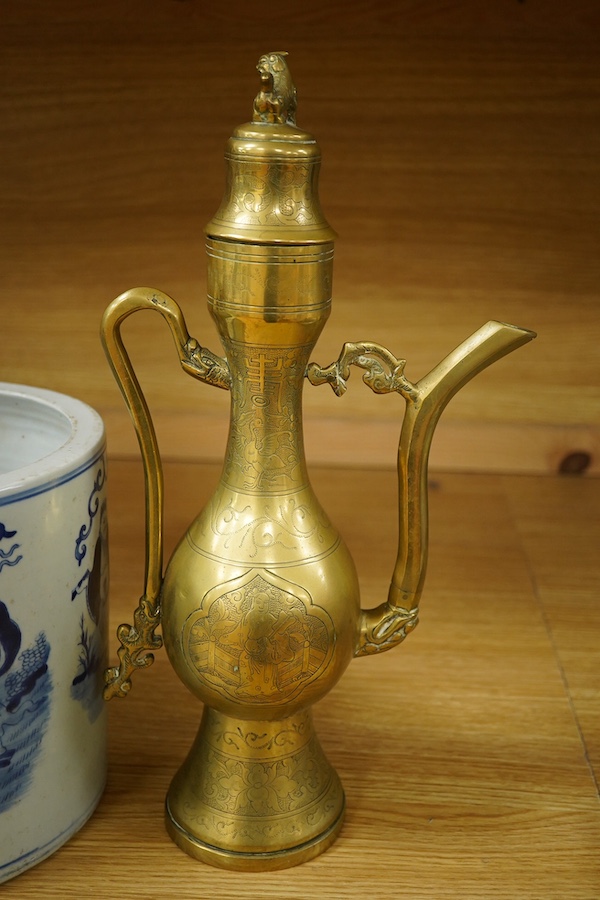 A Chinese cylindrical blue and white brush pot and a brass ewer, largest 39cm high. Condition - fair